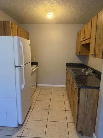 a kitchen with a refrigerator and a stove