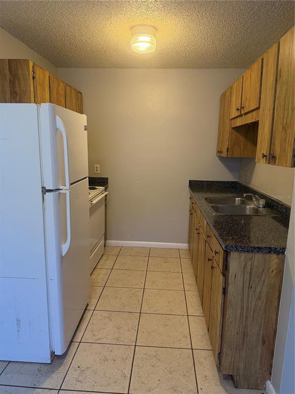3020 Allred Drive, Unit C Auburndale, FL 33823 - Photo 2 of 6 a kitchen with a refrigerator and a stove