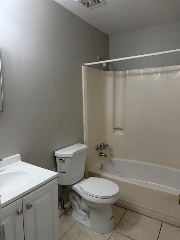3020 Allred Drive, Unit C Auburndale, FL 33823 - Photo 4 of 6 a bathroom with a toilet a sink and a shower