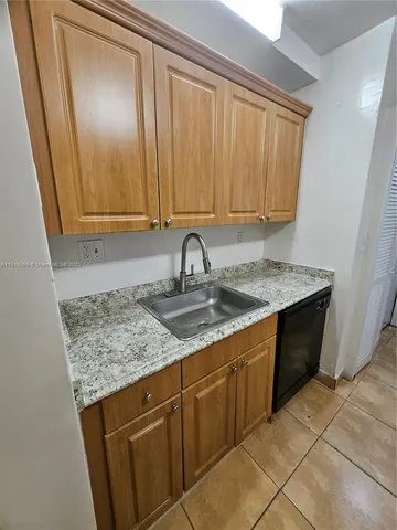 a view of a sink and cabinets