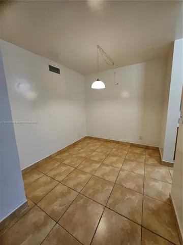 a view of a room with an empty space and a sink