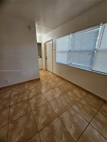 a view of a kitchen with white cabinets and a sink