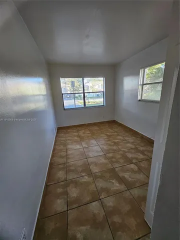 a view of an empty room and closet area