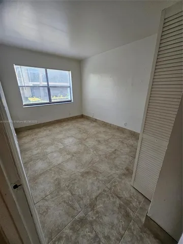 a view of a hallway and a door