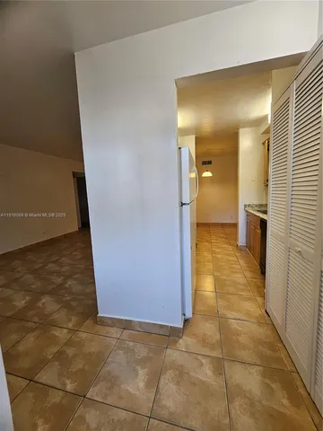 a view of a hallway with a dining room