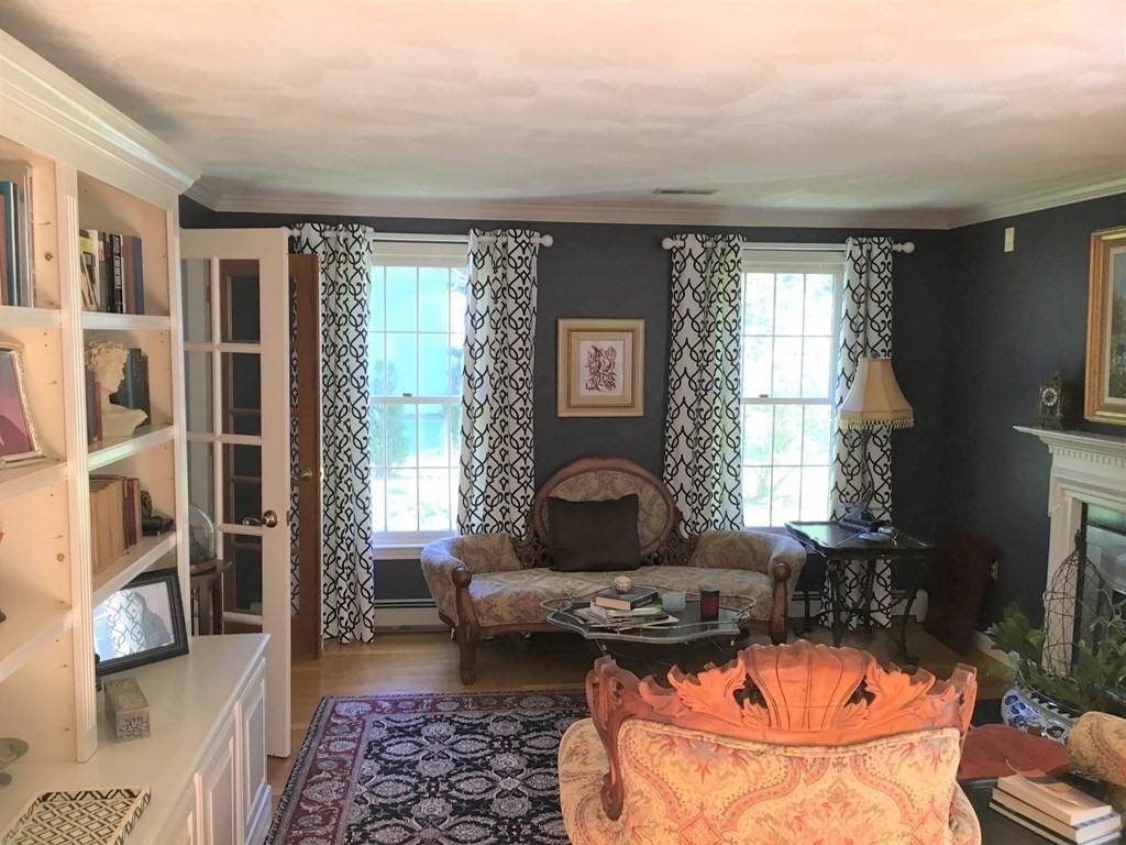 9 Virginia Ridge Road Sudbury, MA 01776 - Photo 17 of 40 a living room with furniture a flat screen tv and a large window