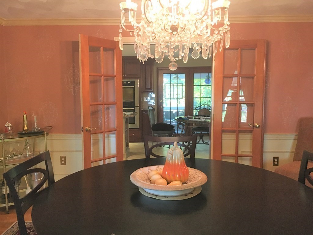 9 Virginia Ridge Road Sudbury, MA 01776 - Photo 20 of 40 a living room with furniture and a chandelier