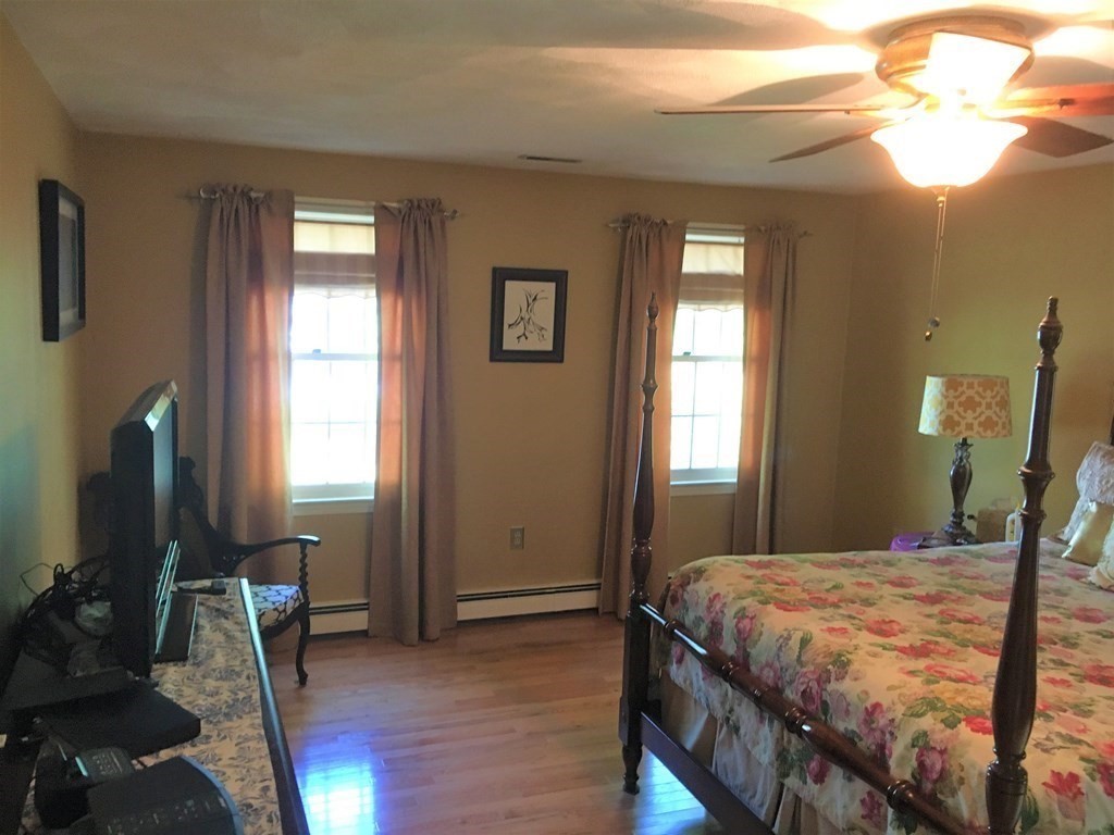 9 Virginia Ridge Road Sudbury, MA 01776 - Photo 22 of 40 a bedroom with a bed and a chandelier