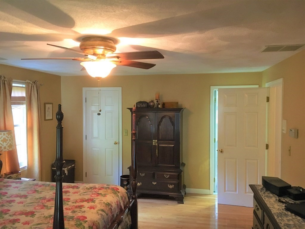 9 Virginia Ridge Road Sudbury, MA 01776 - Photo 23 of 40 a bedroom with a bed and wooden floor
