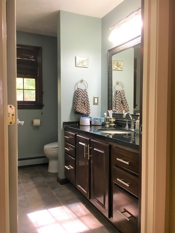 9 Virginia Ridge Road Sudbury, MA 01776 - Photo 24 of 40 a bathroom with a toilet sink and mirror