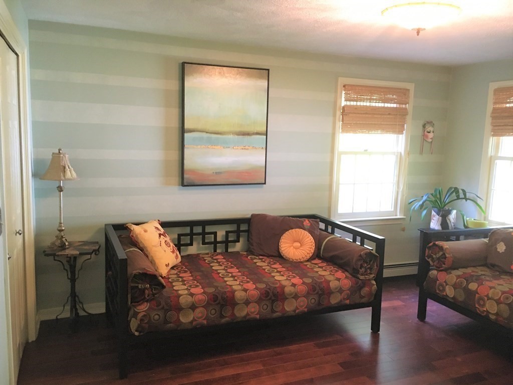 9 Virginia Ridge Road Sudbury, MA 01776 - Photo 27 of 40 a bedroom with a bed and wooden floor