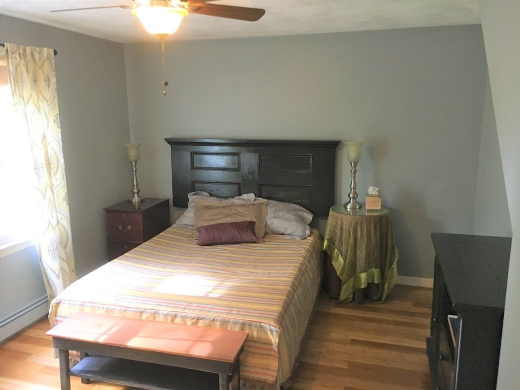 9 Virginia Ridge Road Sudbury, MA 01776 - Photo 29 of 40 a bedroom with a bed and wooden floor