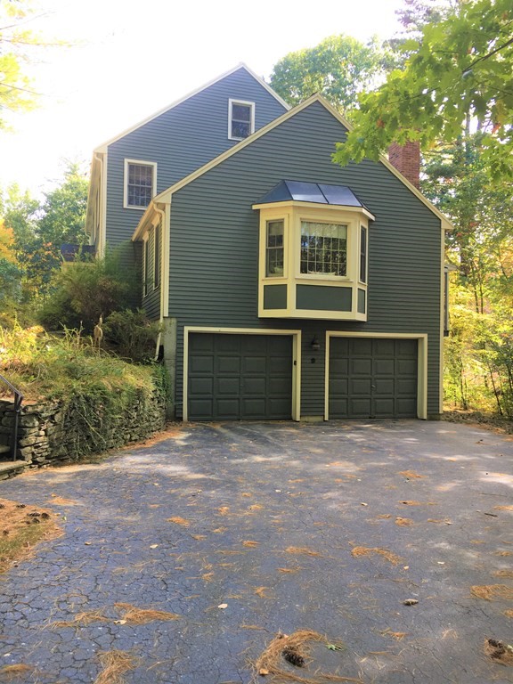 9 Virginia Ridge Road Sudbury, MA 01776 - Photo 4 of 40 a front view of a house with a yard and garage