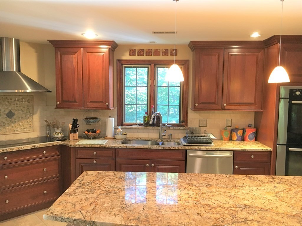 9 Virginia Ridge Road Sudbury, MA 01776 - Photo 9 of 40 a kitchen with a sink a stove and cabinets