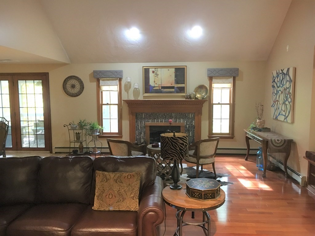 9 Virginia Ridge Road Sudbury, MA 01776 - Photo 10 of 40 a living room with furniture and a fireplace