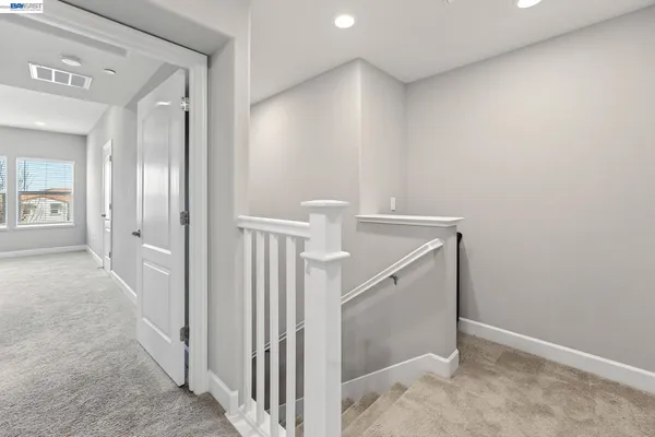 a view of a hallway to rooms