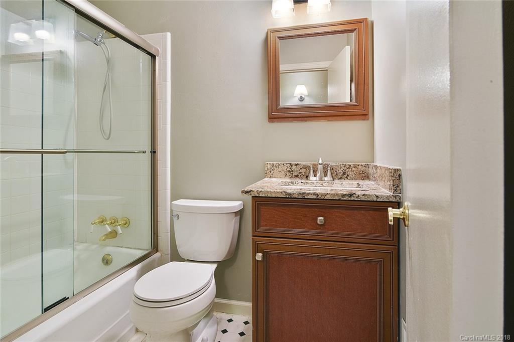 5523 Seacroft Road Charlotte, NC 28210 - Photo 11 of 15 a bathroom with a toilet sink vanity and shower