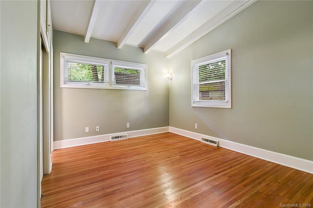 5523 Seacroft Road Charlotte, NC 28210 - Photo 12 of 15 an empty room with wooden floor and windows