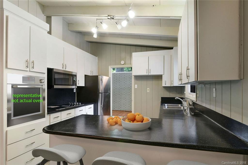 5523 Seacroft Road Charlotte, NC 28210 - Photo 3 of 15 a kitchen with a sink a stove and refrigerator