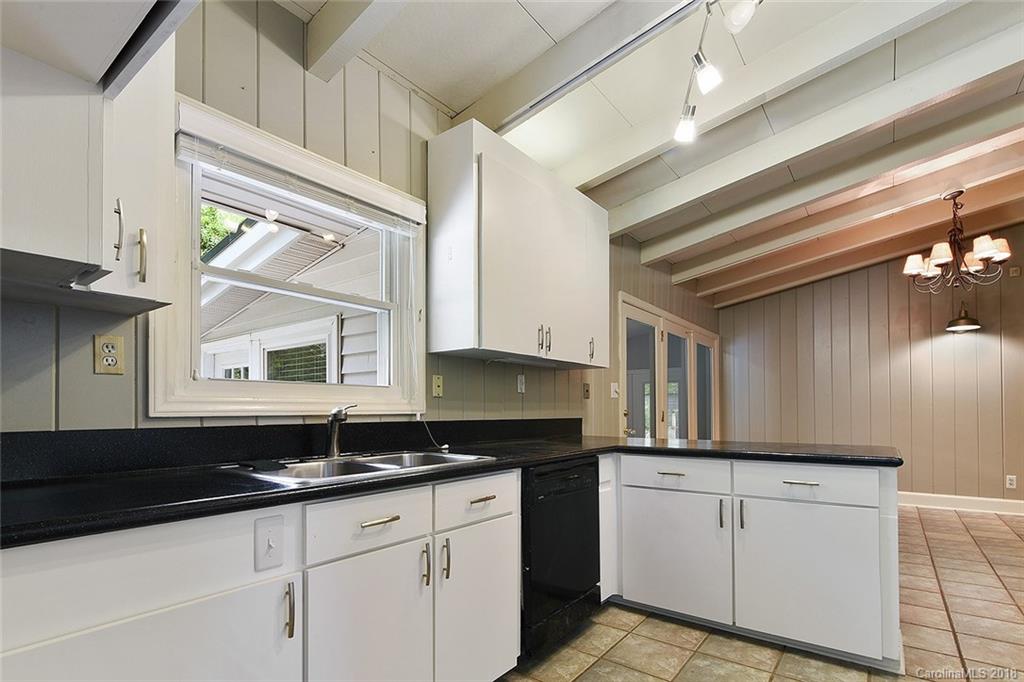 5523 Seacroft Road Charlotte, NC 28210 - Photo 5 of 15 a kitchen with granite countertop a sink and a stove
