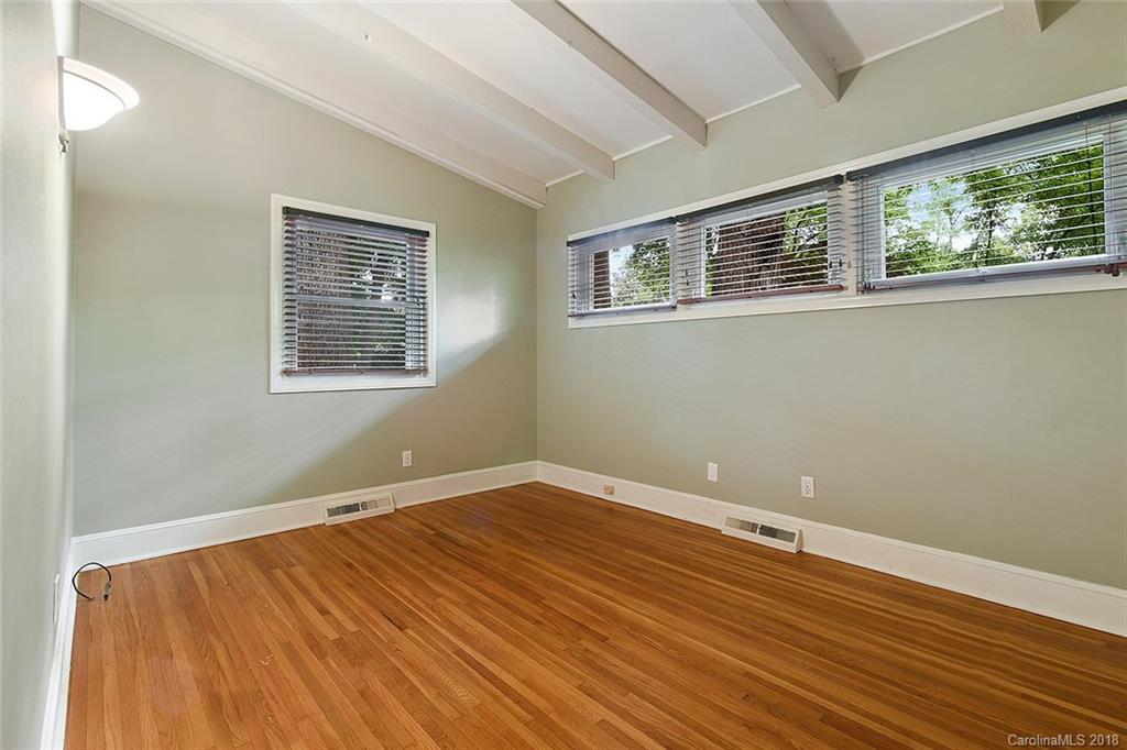 5523 Seacroft Road Charlotte, NC 28210 - Photo 10 of 15 a view of an empty room with wooden floor and a window