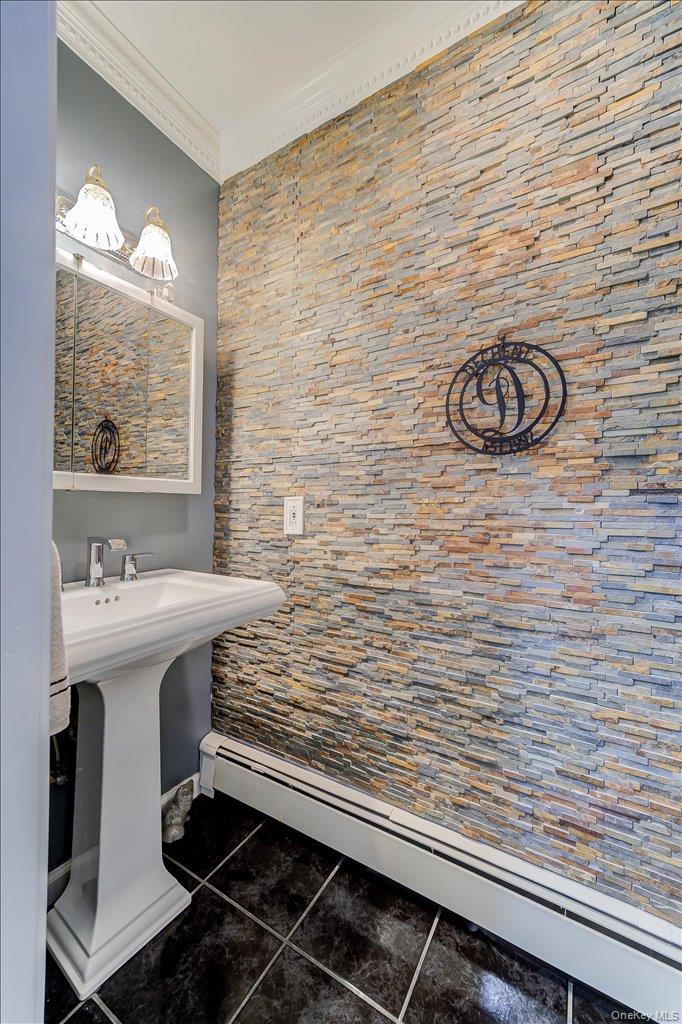 104 Wiccopee Road Putnam Valley, NY 10579 - Photo 18 of 50 Pedestal sink featuring a chrome faucet, illuminated by a wall-mounted light fixture