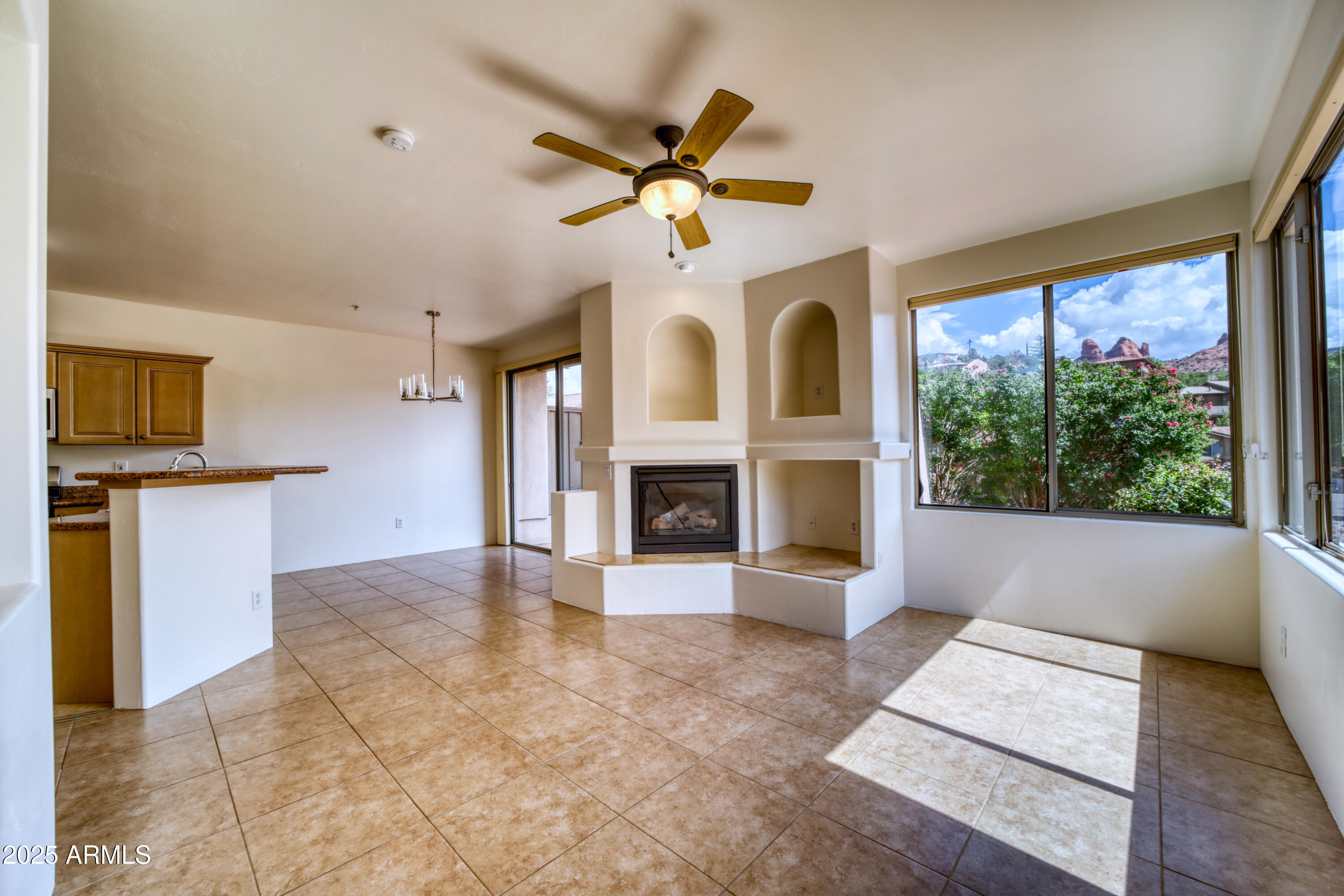 520 Jordan Road, Unit 4 Sedona, AZ 86336 - Photo 4 of 29 a view of an empty room with a fireplace and a window
