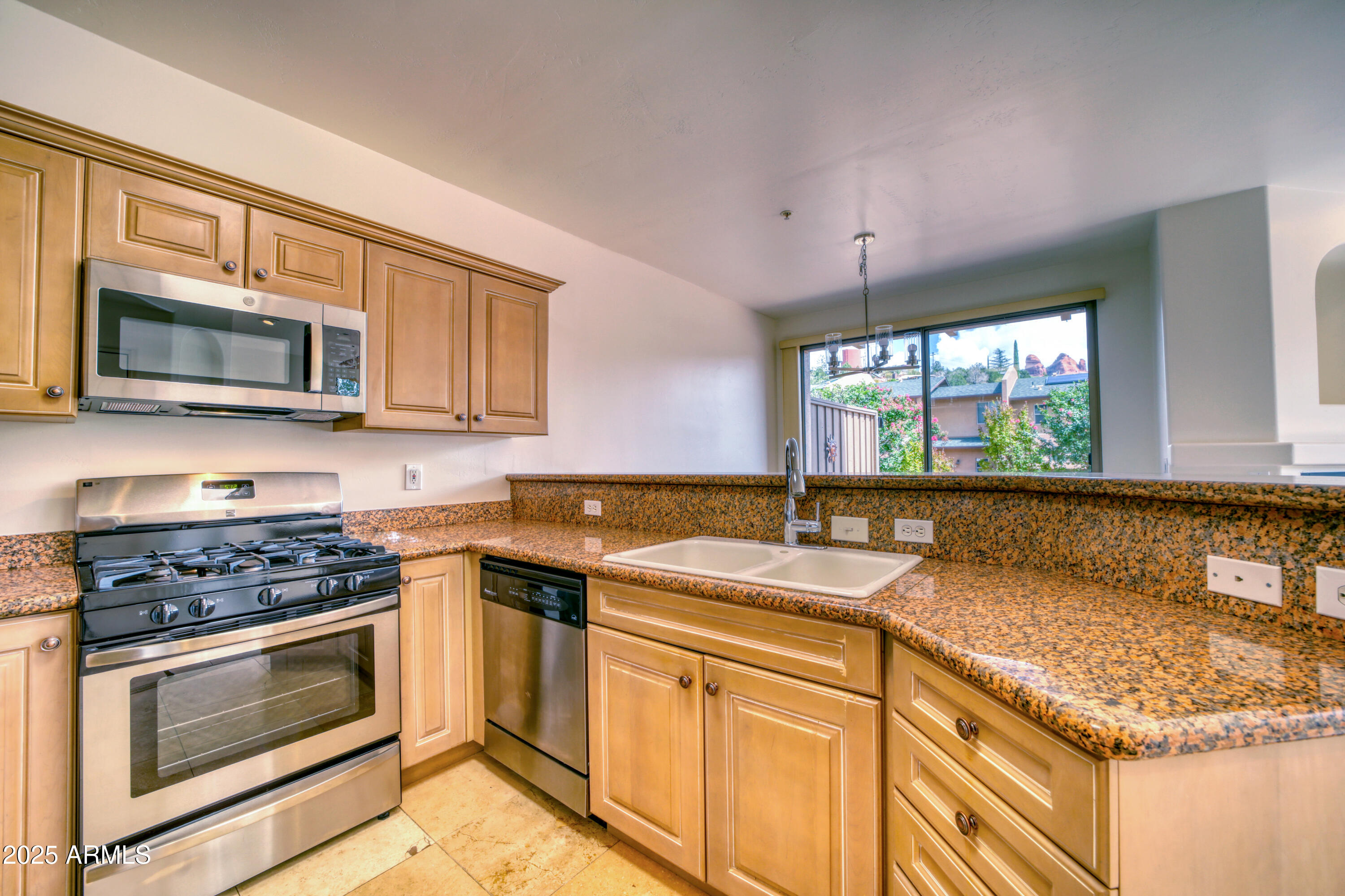 520 Jordan Road, Unit 4 Sedona, AZ 86336 - Photo 10 of 29 a kitchen with stainless steel appliances granite countertop a sink stove microwave and cabinets