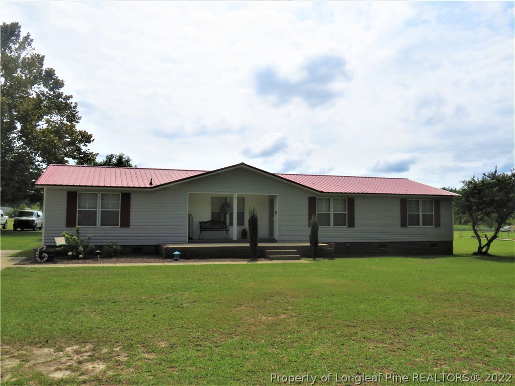 7684 Smithfield Road Godwin, NC 28344 - Photo 1 of 23 a front view of a house with garden