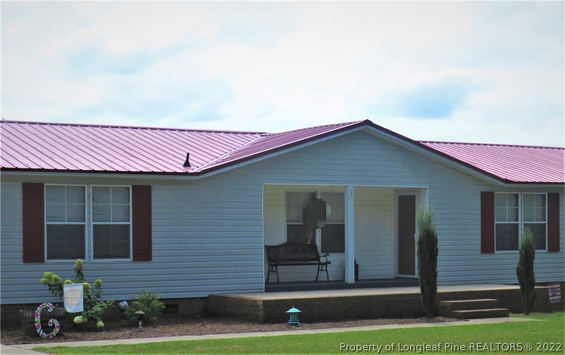7684 Smithfield Road Godwin, NC 28344 - Photo 2 of 23 a front view of a house with a yard