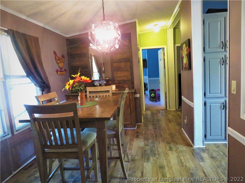 7684 Smithfield Road Godwin, NC 28344 - Photo 9 of 23 a view of a dining room with furniture and chandelier