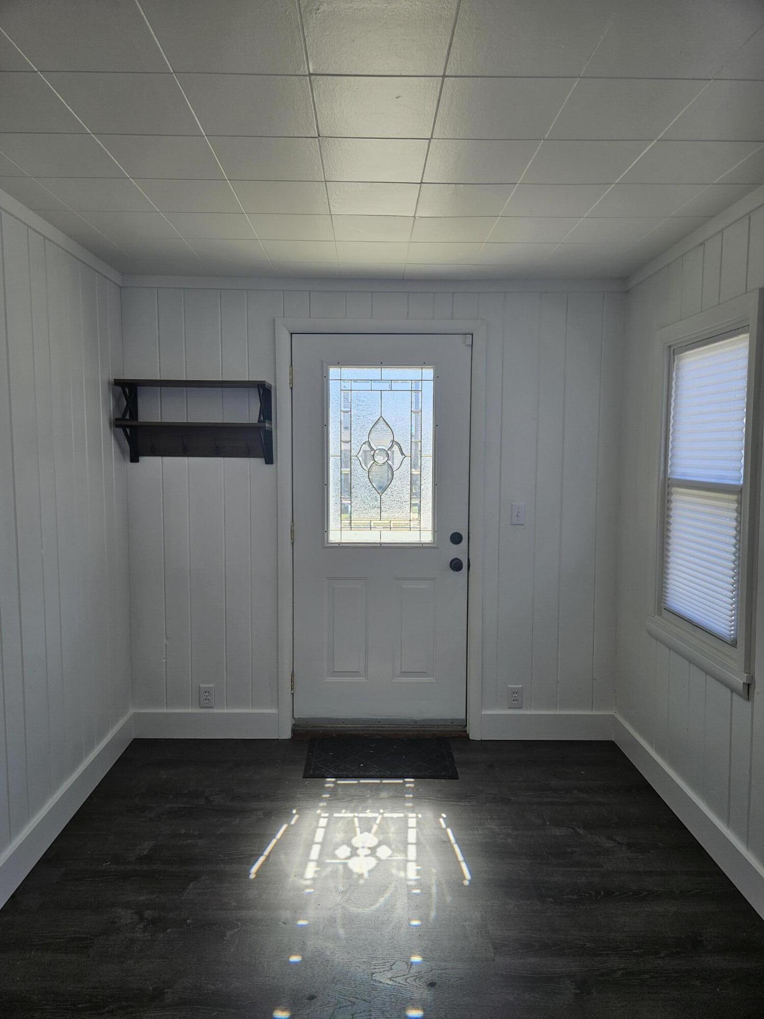 218 Fogarty Street Michigan City, IN 46360 - Photo 3 of 13 an empty room with wooden floor and windows
