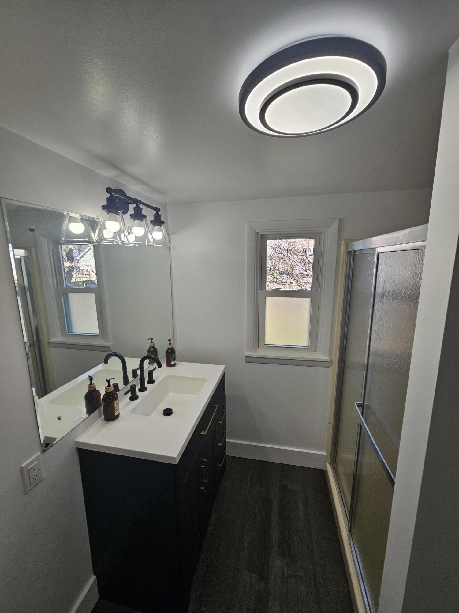 218 Fogarty Street Michigan City, IN 46360 - Photo 4 of 13 a bathroom with a double vanity sink and a mirror