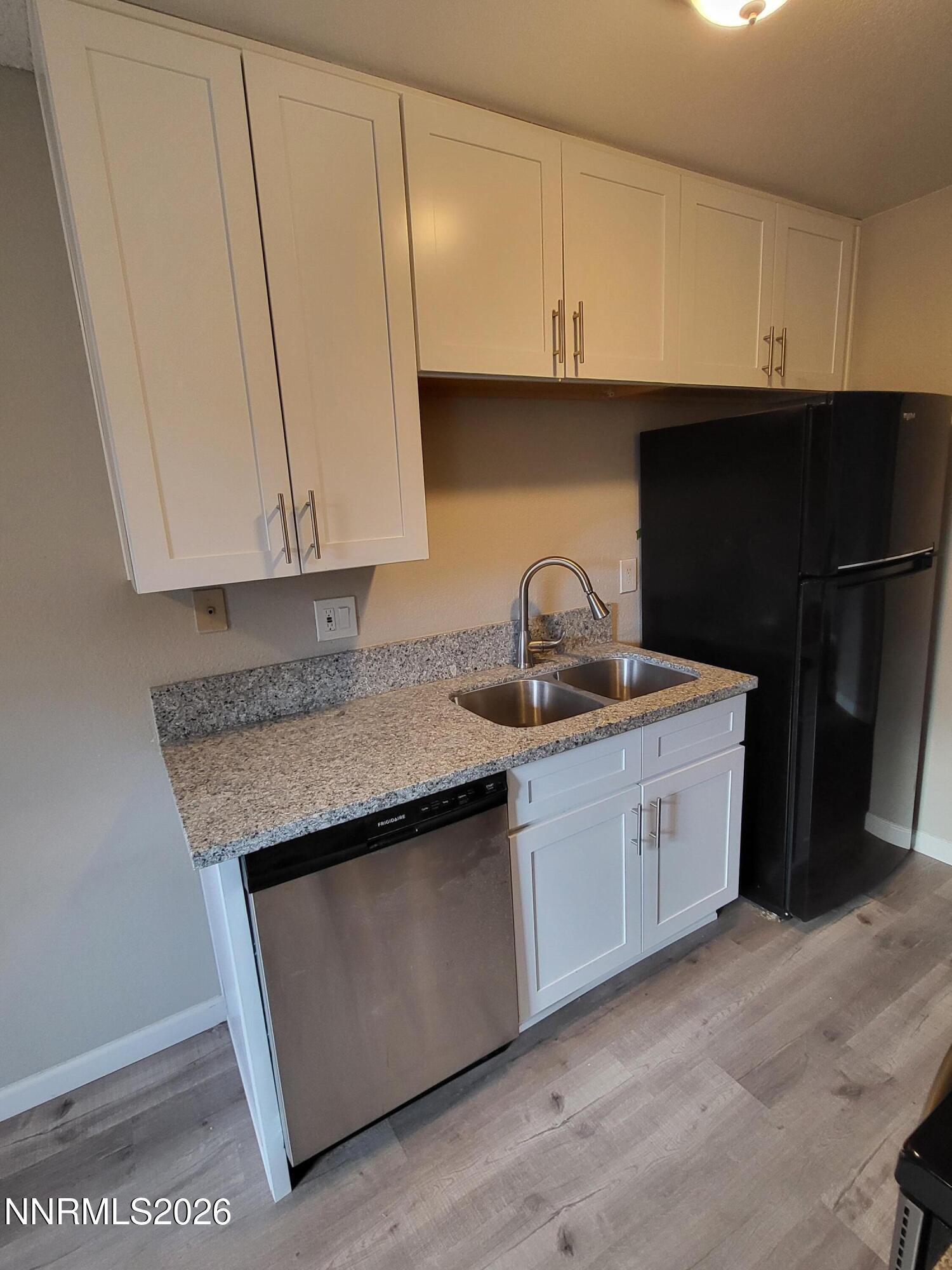 4606 Neil Road, Unit 197 Reno, NV 89502 - Photo 21 of 26 a kitchen with stainless steel appliances granite countertop a sink a stove and a refrigerator