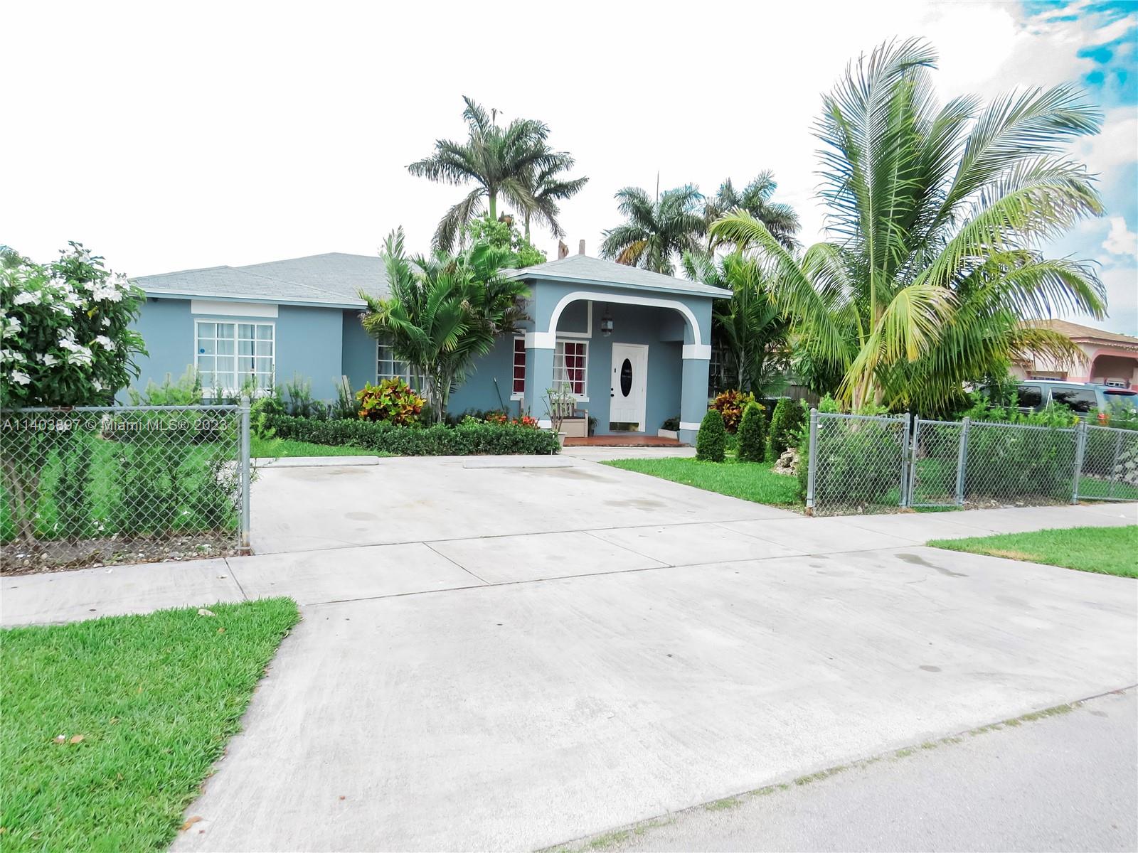 14225 Southwest 296th Street Homestead, FL 33033 - Photo 1 of 37 a front view of house with yard and green space