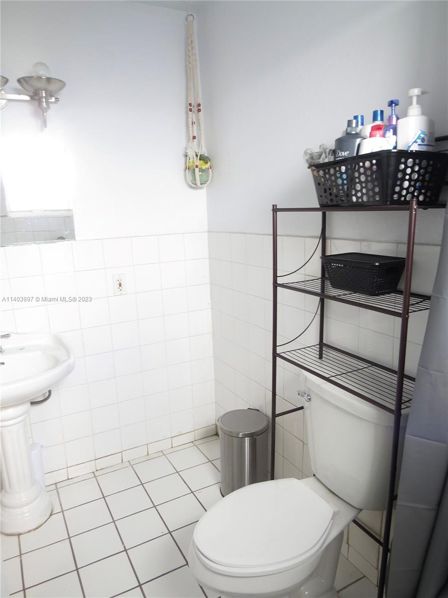 14225 Southwest 296th Street Homestead, FL 33033 - Photo 14 of 37 a bathroom with a toilet and a sink
