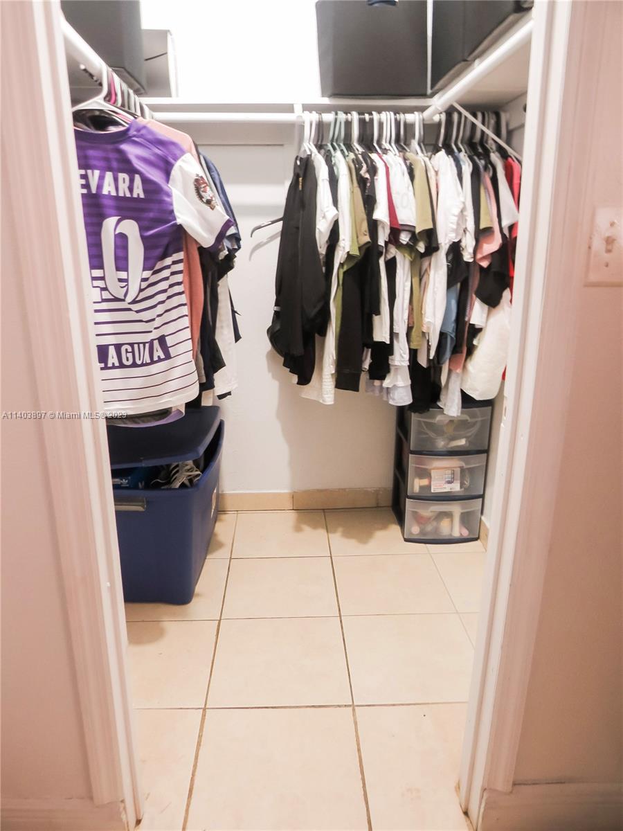 14225 Southwest 296th Street Homestead, FL 33033 - Photo 16 of 37 a view of walk in closet with clothes and shoes