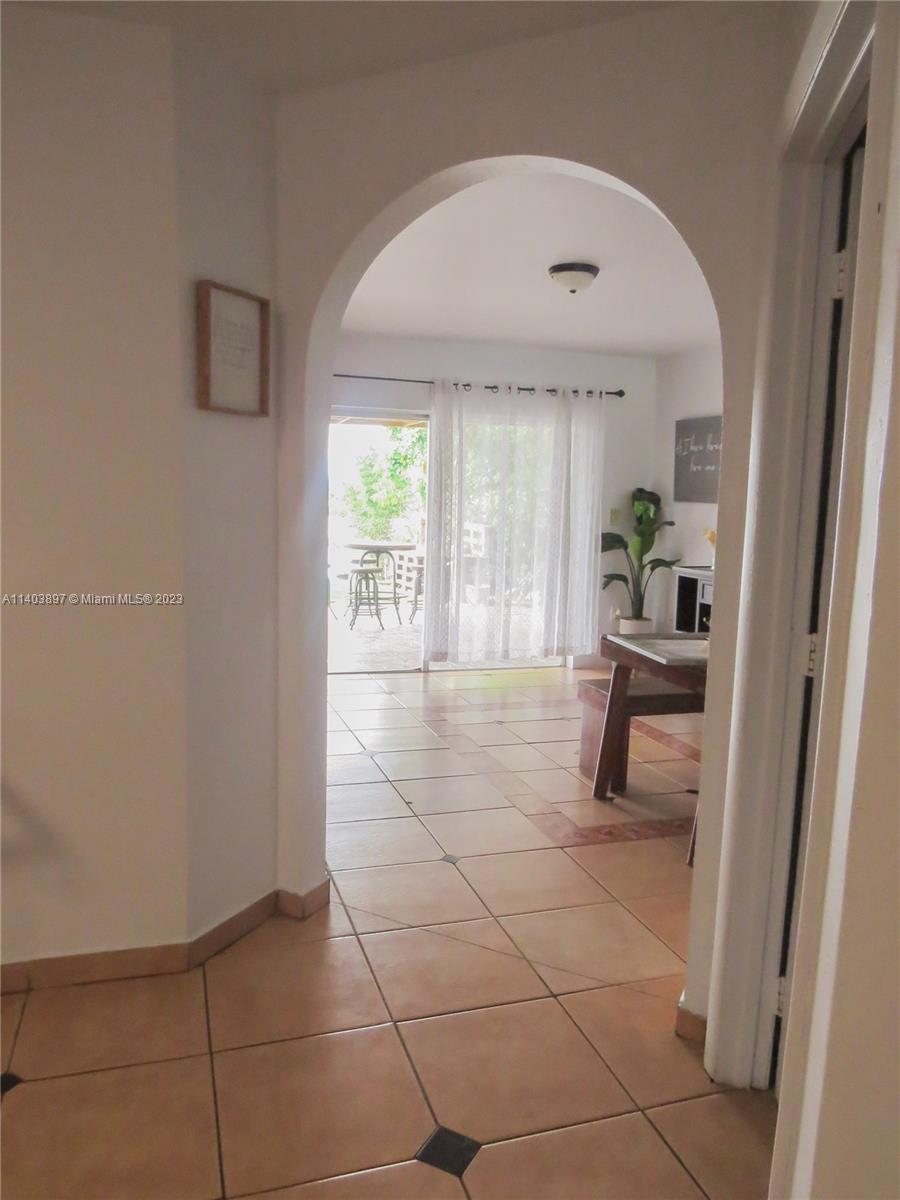 14225 Southwest 296th Street Homestead, FL 33033 - Photo 19 of 37 a living room with a bath tub and couches next to a window