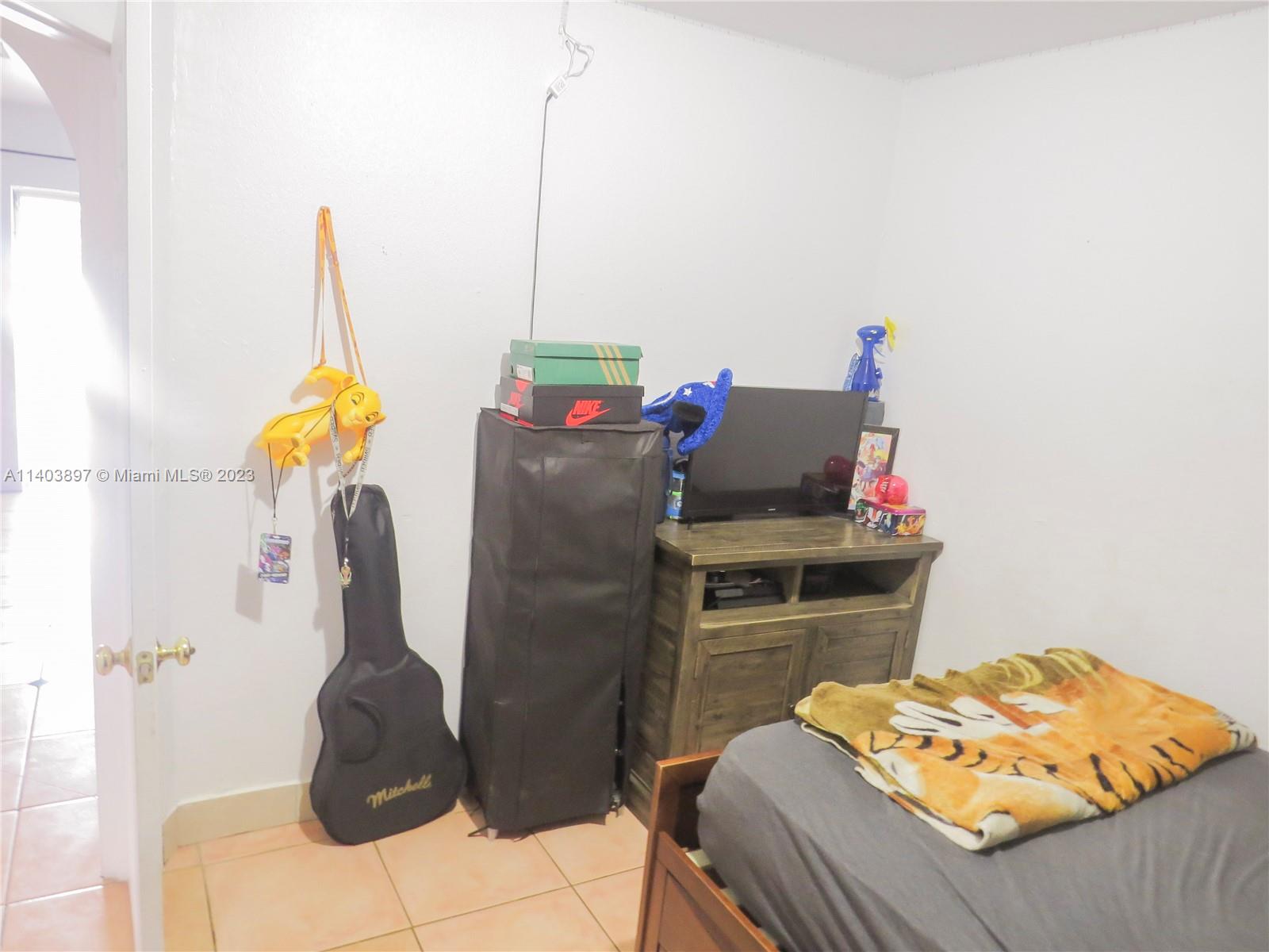 14225 Southwest 296th Street Homestead, FL 33033 - Photo 20 of 37 a bedroom with a bed and a table