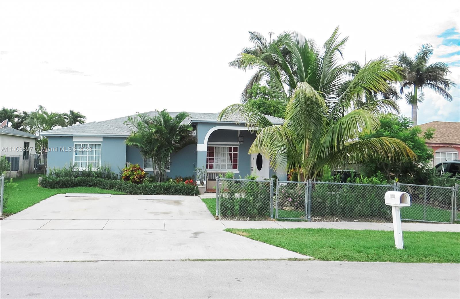 14225 Southwest 296th Street Homestead, FL 33033 - Photo 2 of 37 a front view of a house with garden