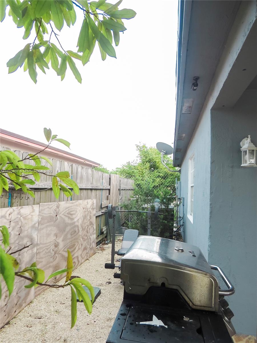 14225 Southwest 296th Street Homestead, FL 33033 - Photo 32 of 37 a view of backyard with a tub and trees in the background