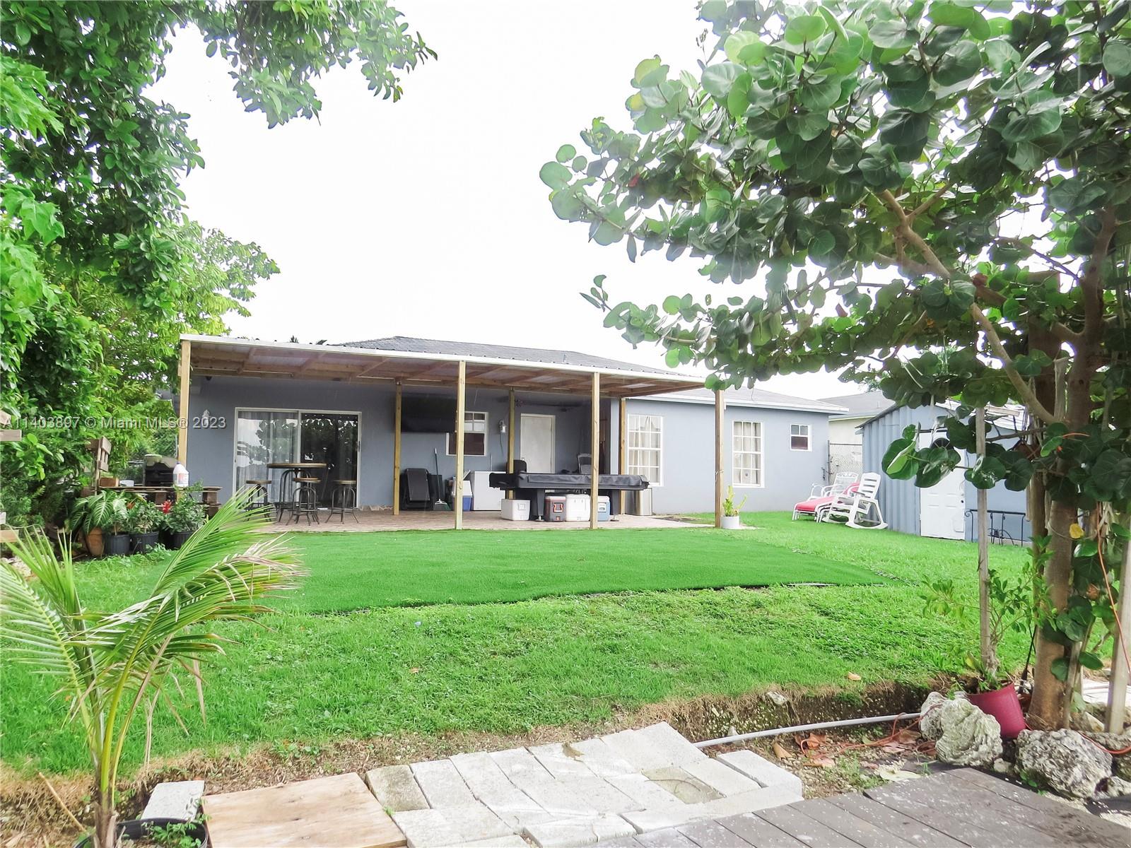 14225 Southwest 296th Street Homestead, FL 33033 - Photo 35 of 37 a front view of house with a garden and patio