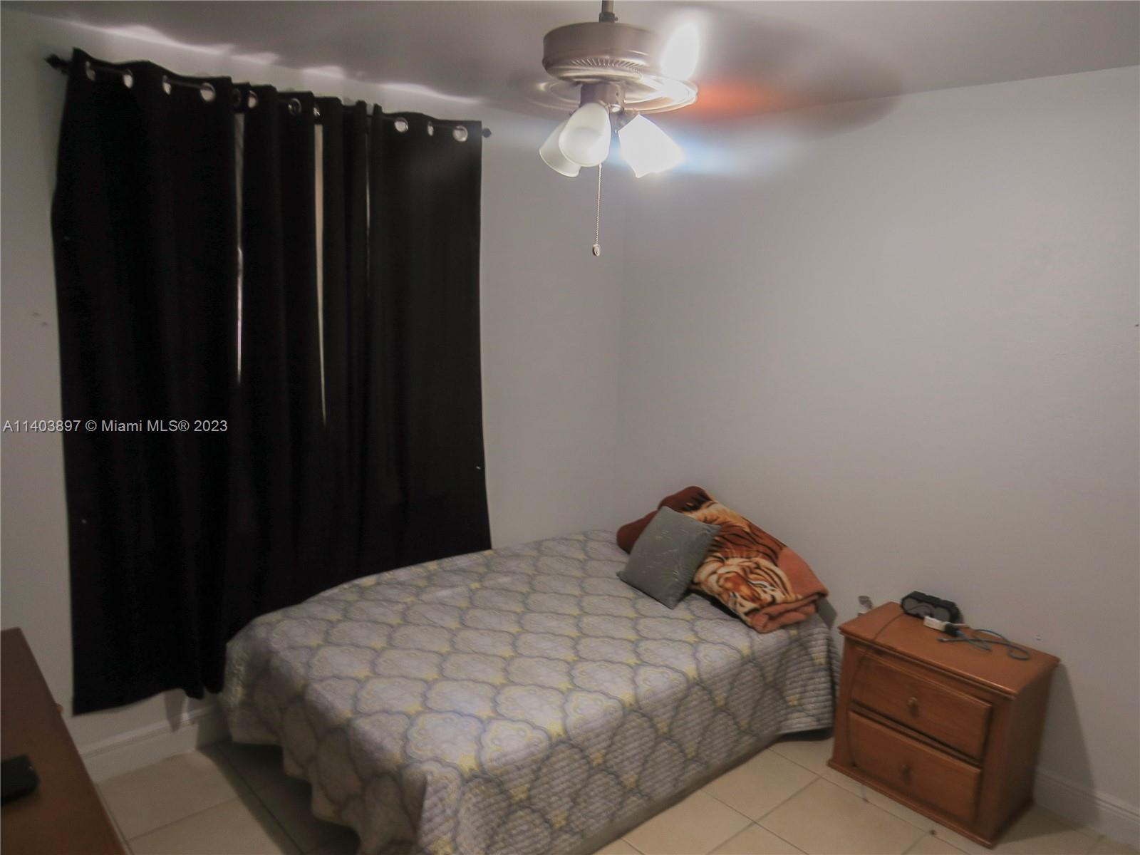 14225 Southwest 296th Street Homestead, FL 33033 - Photo 5 of 37 a bedroom with a bed and a cabinet