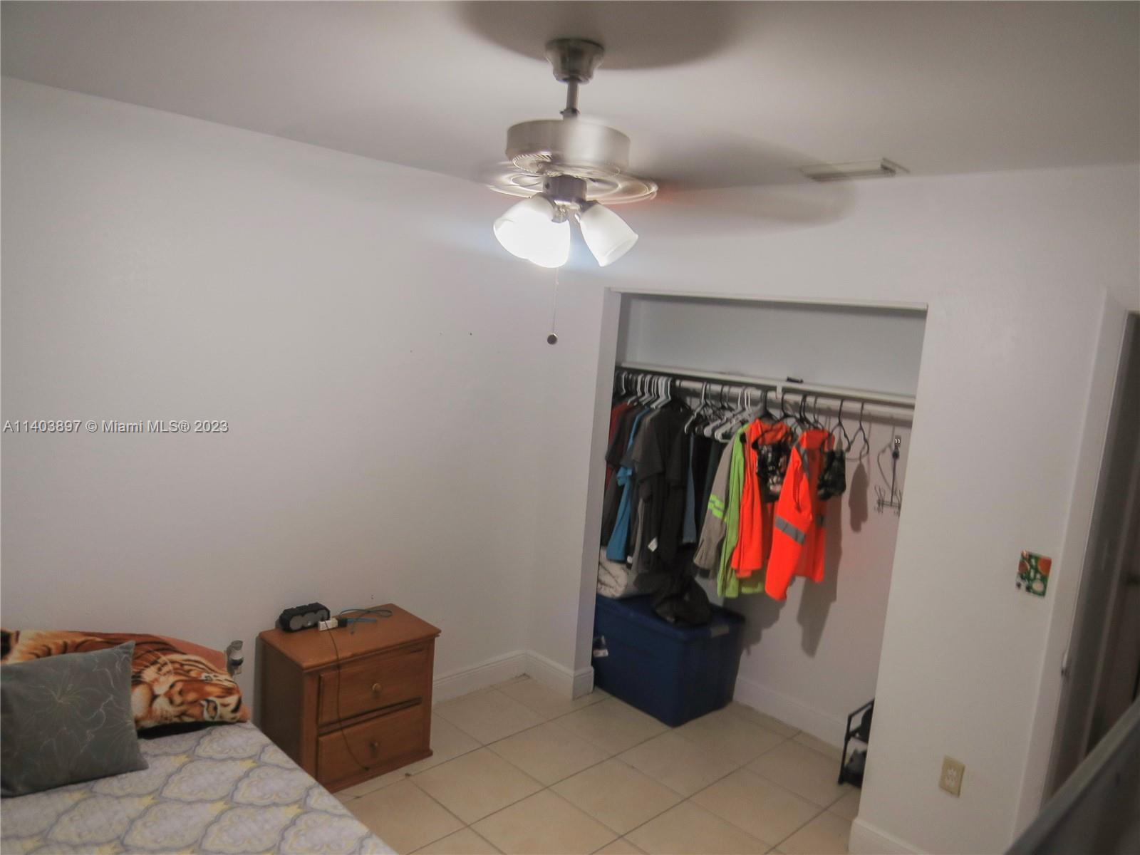 14225 Southwest 296th Street Homestead, FL 33033 - Photo 6 of 37 a view of walk in closet with clothes and shoes