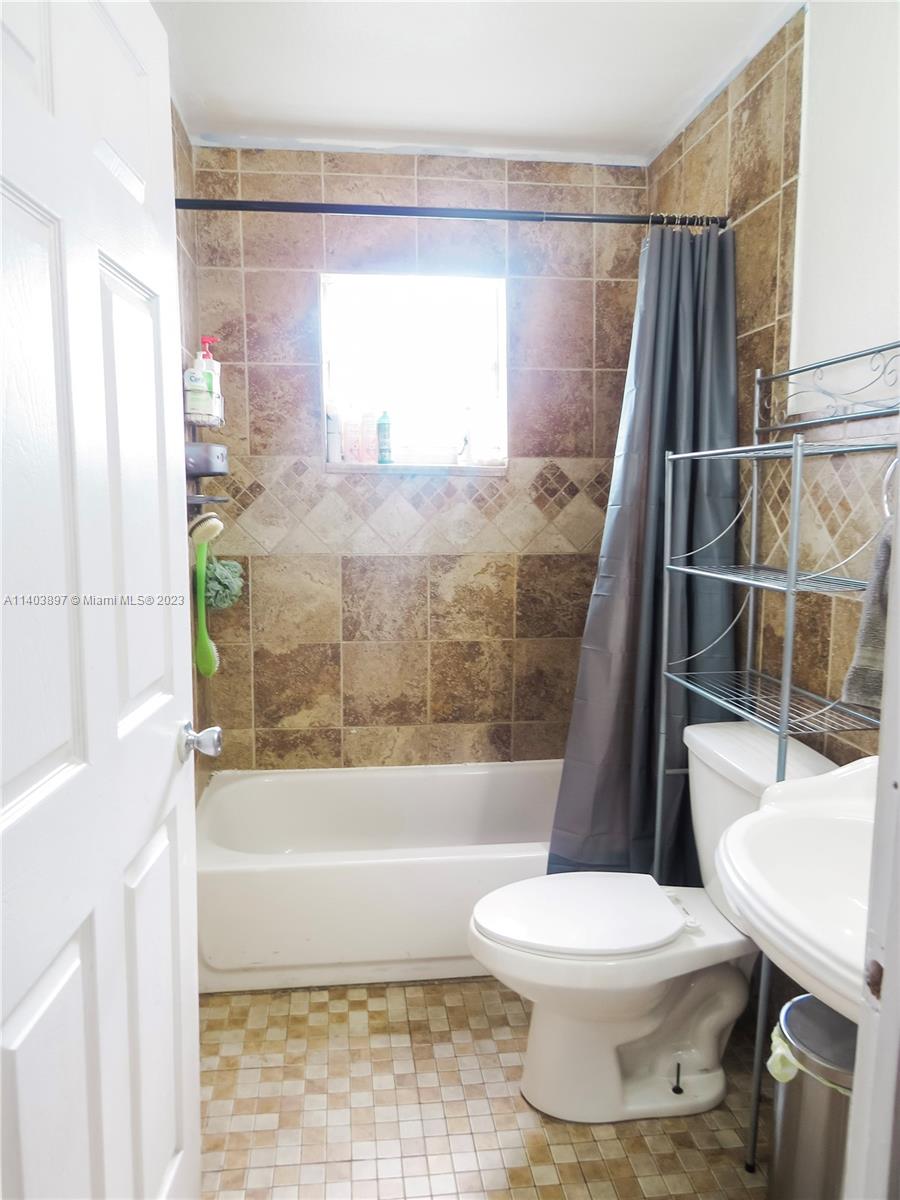 14225 Southwest 296th Street Homestead, FL 33033 - Photo 7 of 37 a bathroom with a toilet and a shower