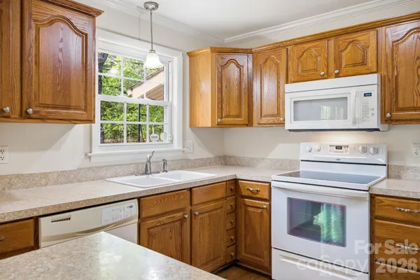 a kitchen with granite countertop cabinets stainless steel appliances and a sink