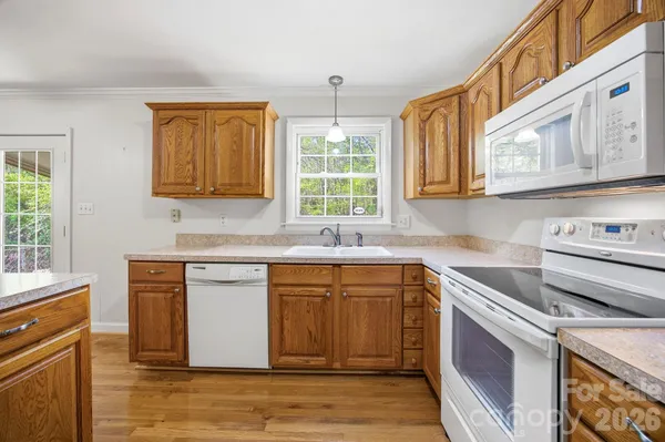 a kitchen with stainless steel appliances granite countertop a sink stove and cabinets