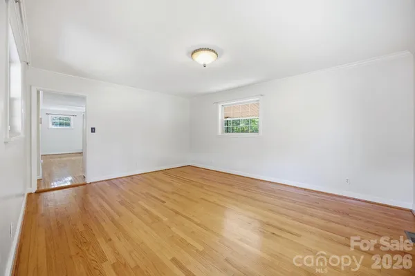 a view of an empty room and wooden floor