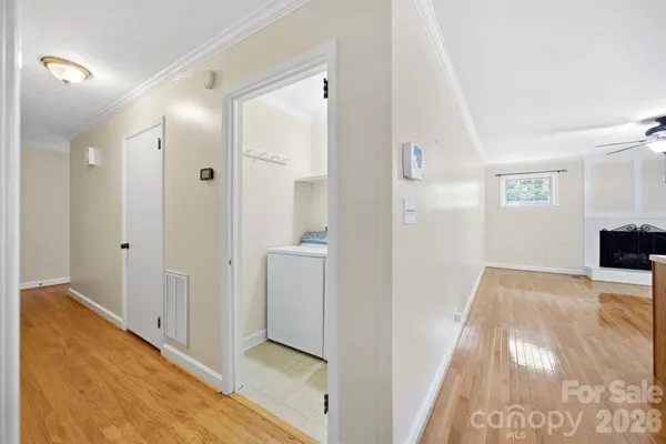 a view of a hallway with wooden floor and staircase