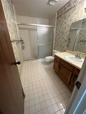 a bathroom with a sink a mirror and shower